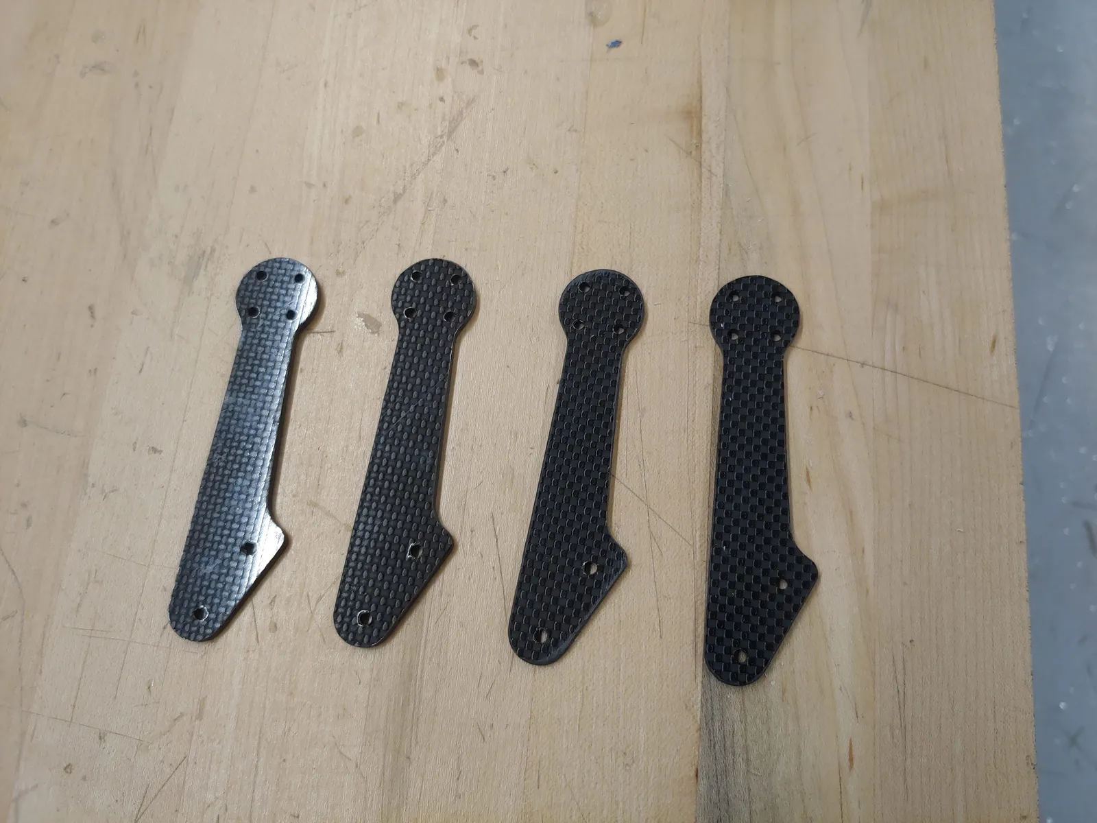 I cut the v2 arms out of 3mm carbon fiber sheet using a CNC router. Each arm mounts to the main body with 2 M3 screws, and are easily replaceable if they break