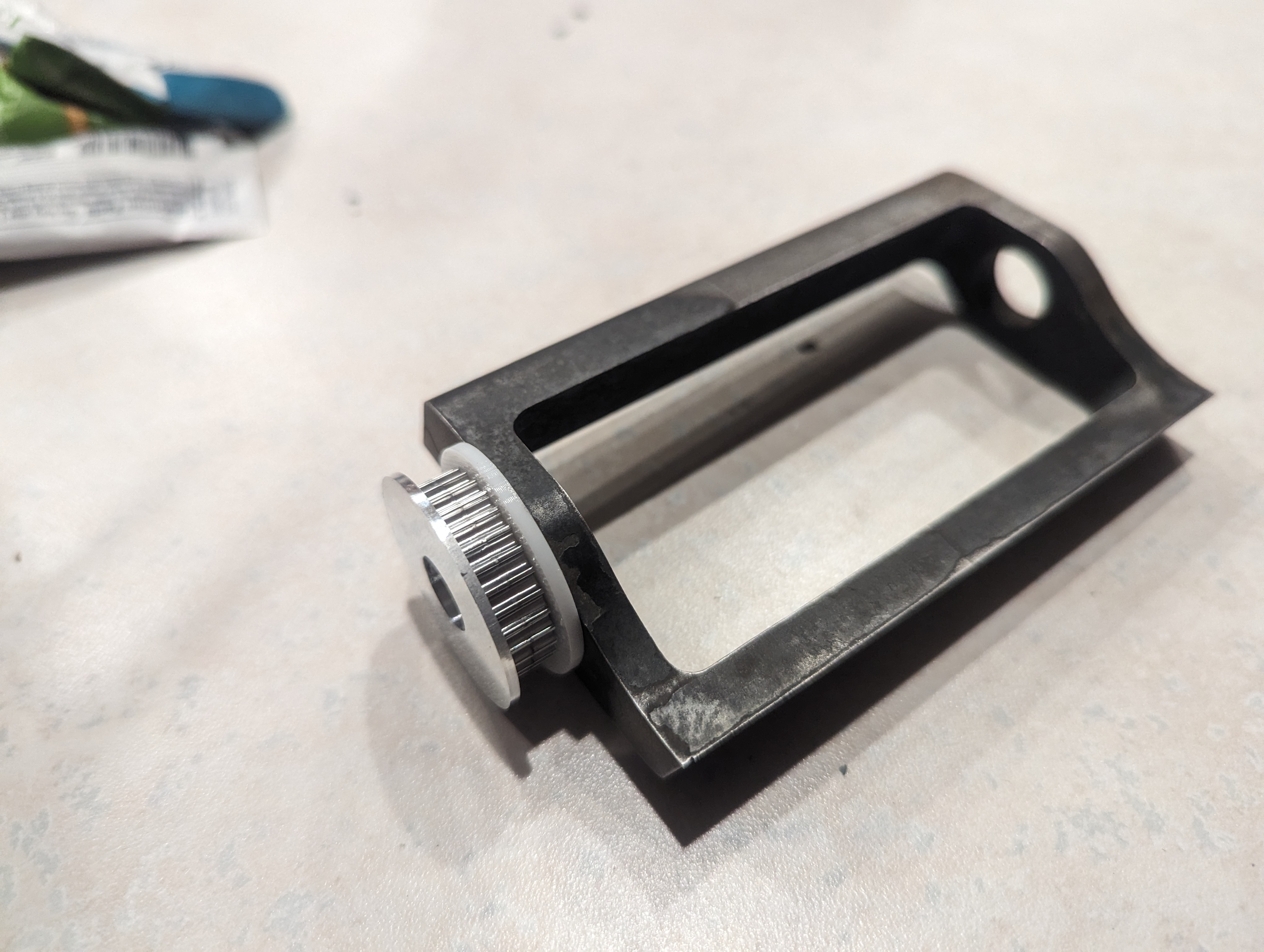 A heat-treated drum with its pulley. The white TPU insert helps reduce shock transfer to the weapon motor