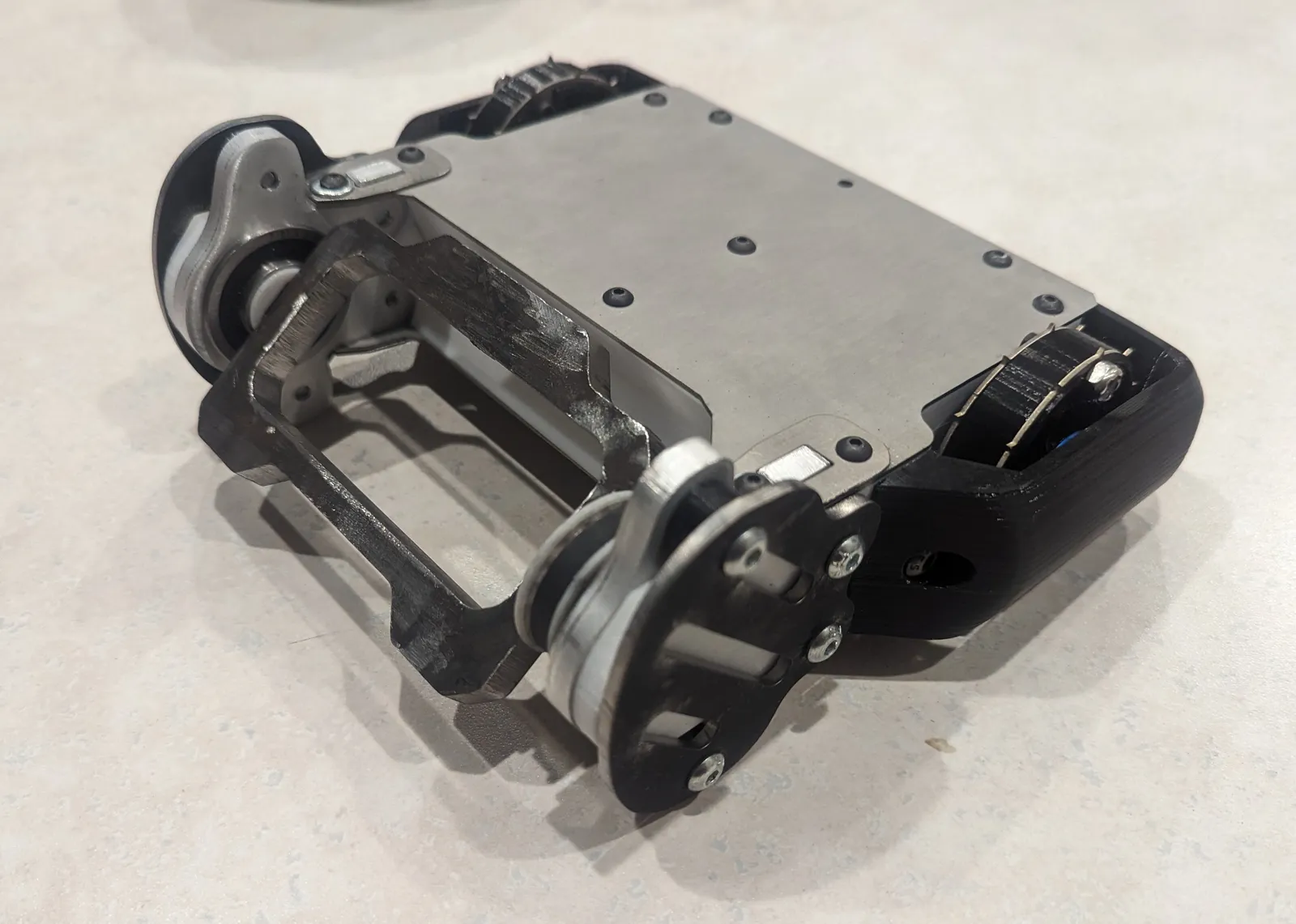 Version 2.1 with titanium top/bottom plates, TPU back/wheel armor, AR500 front side armor, and cleated wheels for better traction on wood floors