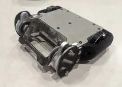 Thumbnail: Version 2.1 with titanium top/bottom plates, TPU back/wheel armor, AR500 front side armor, and cleated wheels for better traction on wood floors