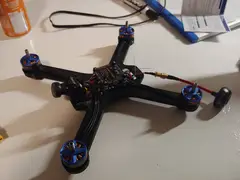 Thumbnail: Flight controller is mounted on top of the ESC, and the VTX is mounted underneath the main frame piece