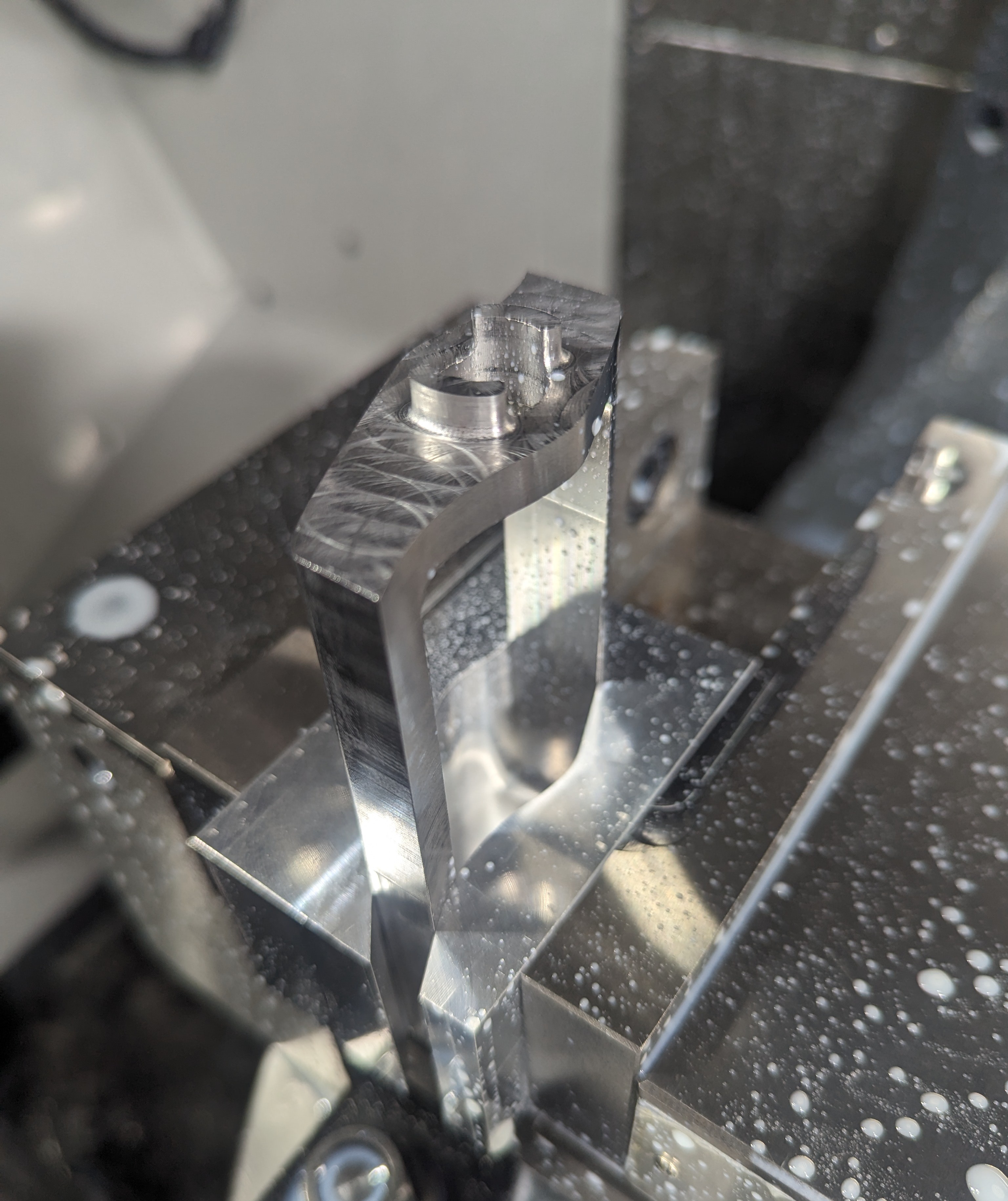 Just-machined drum, clamped in the mill's vise with soft jaws
