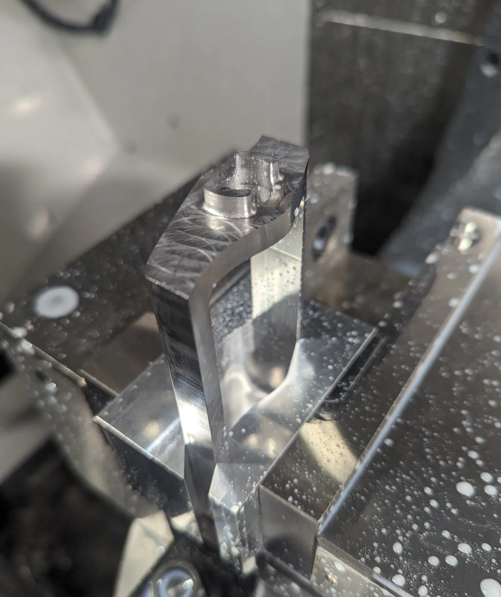 Just-machined drum, clamped in the mill's vise with soft jaws