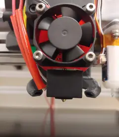 Thumbnail: Hotend and nozzle of the print head, with the custom part cooling duct blowing air from either side