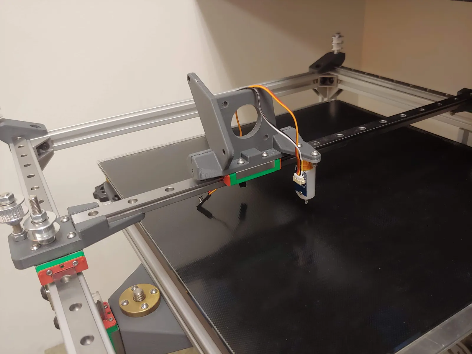 Starting the print head assembly with a bracket to mount the extruder / nozzle, the touch probe, and a cooling fan