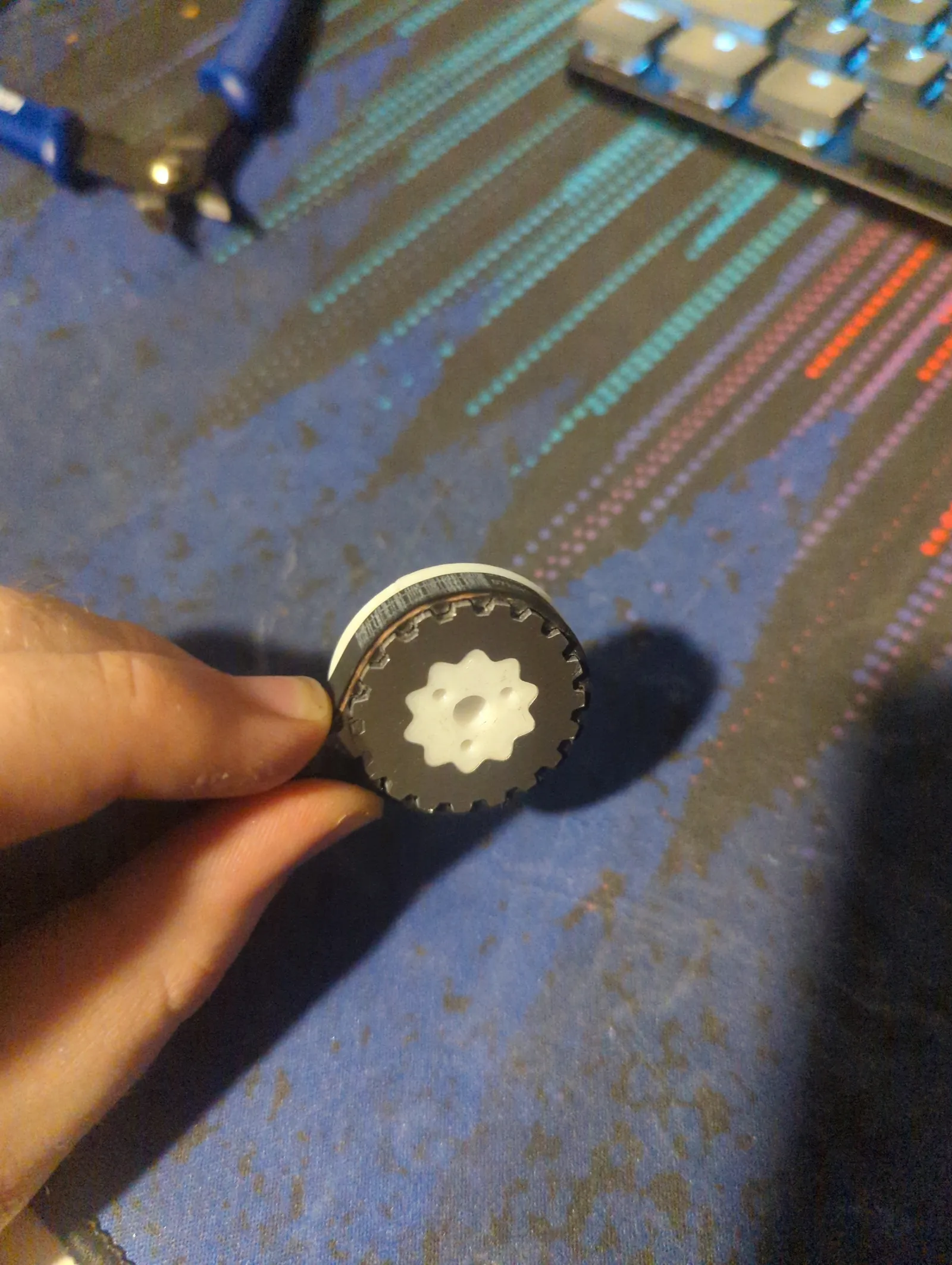 A custom TPU pulley with aluminum teeth made from a stack of laster-cut plates. This solution was much more robust than fully printed pullies, but not as good as the fully CNC version that would replace it in v3