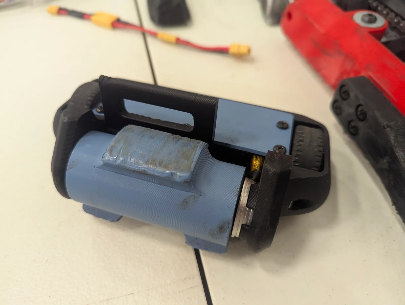 After several matches, mini boi's drum is scuffed and dented, but still functional