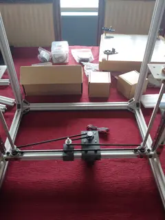 Thumbnail: Initial assembly of the Z-axis belt-driven leadscrew mechanism. The printed brackets can be positioned on the extrusion to set the belt tension